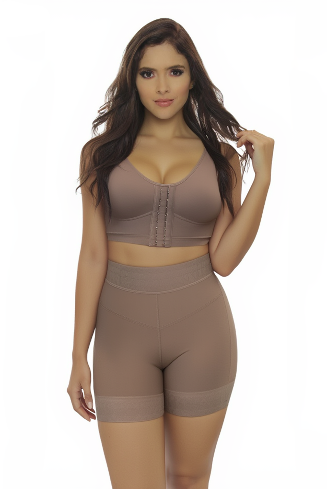 Woman wearing a brown sports bra and shorts set on a white background