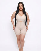 Woman wearing a beige shapewear garment on a white background